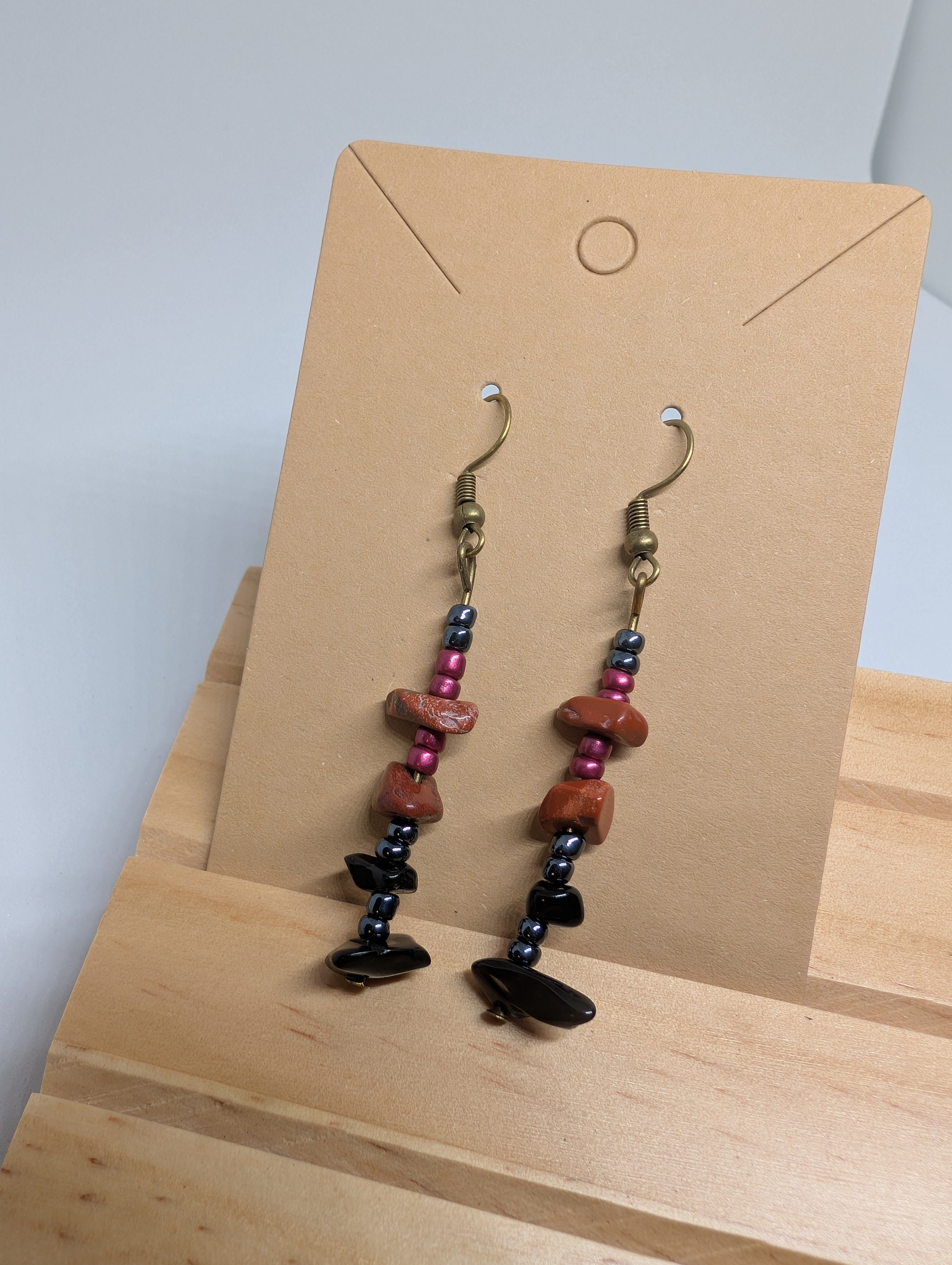 Terracotta And Jet, handmade beaded earrings in orange, black, pink and grey