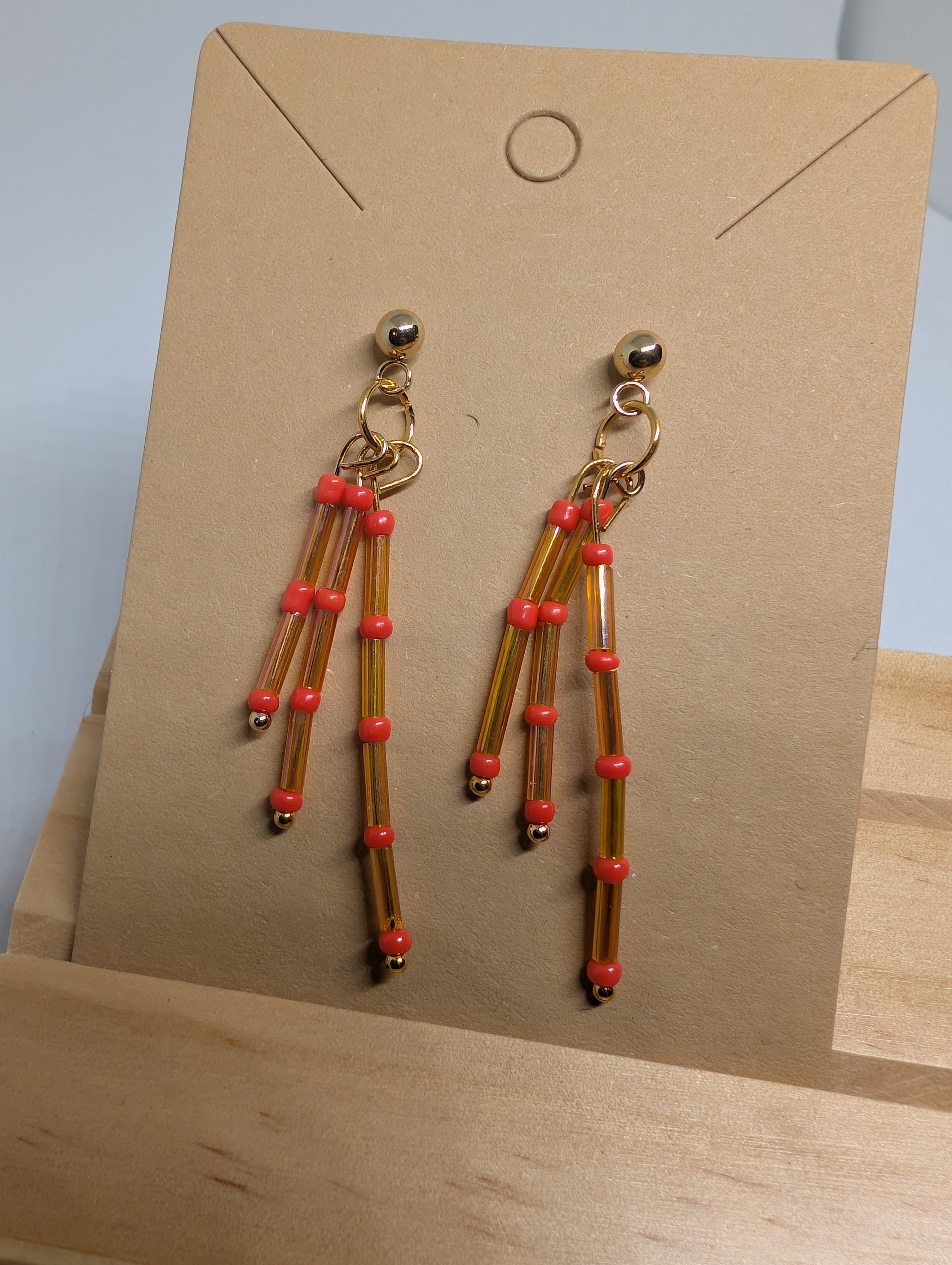 Amber And Coral Fringe, handmade beaded earrings in orange, brown and gold