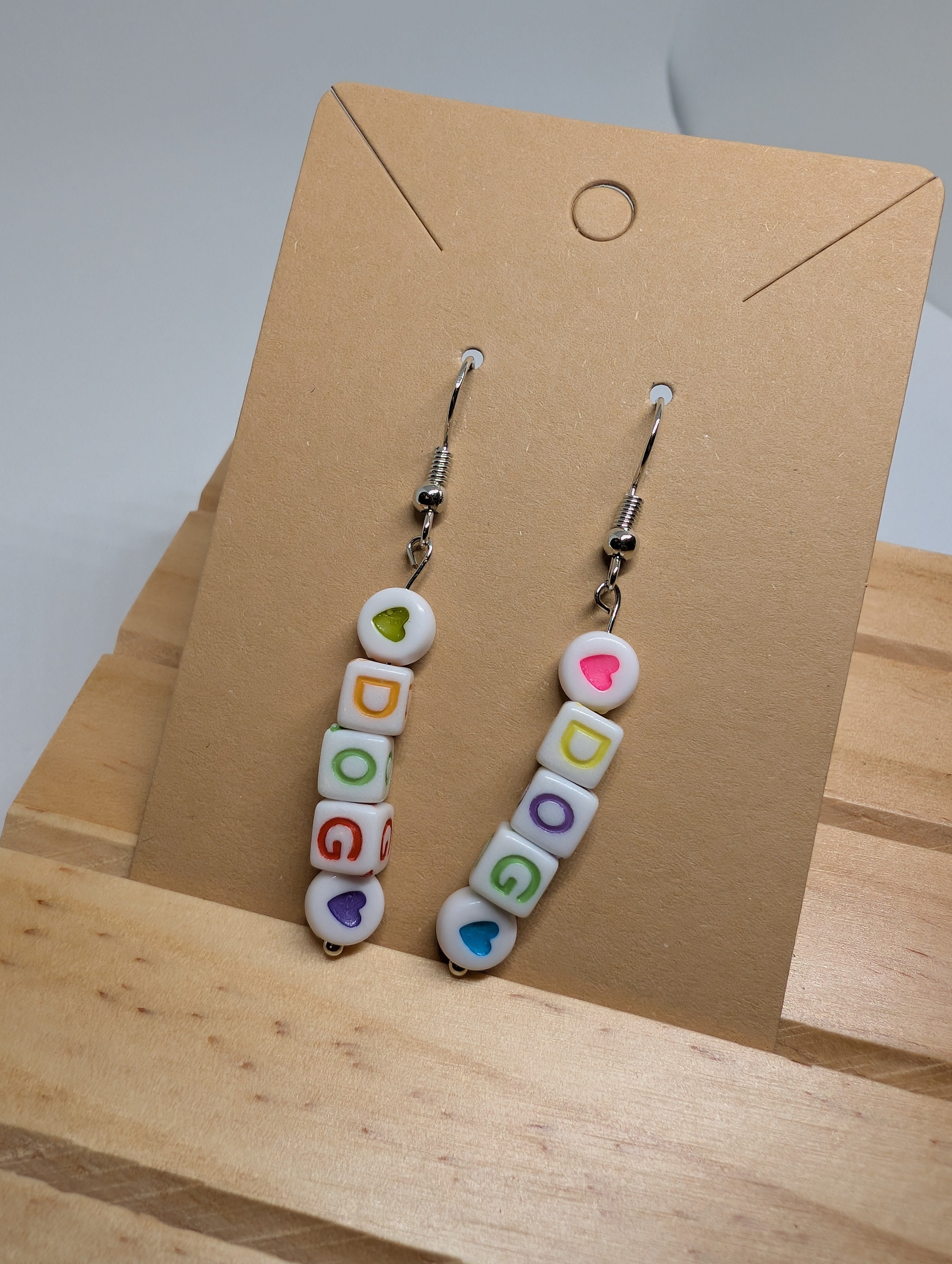 Rainbow Dog Letter Drops, handmade beaded earrings in white, multicolour and silver