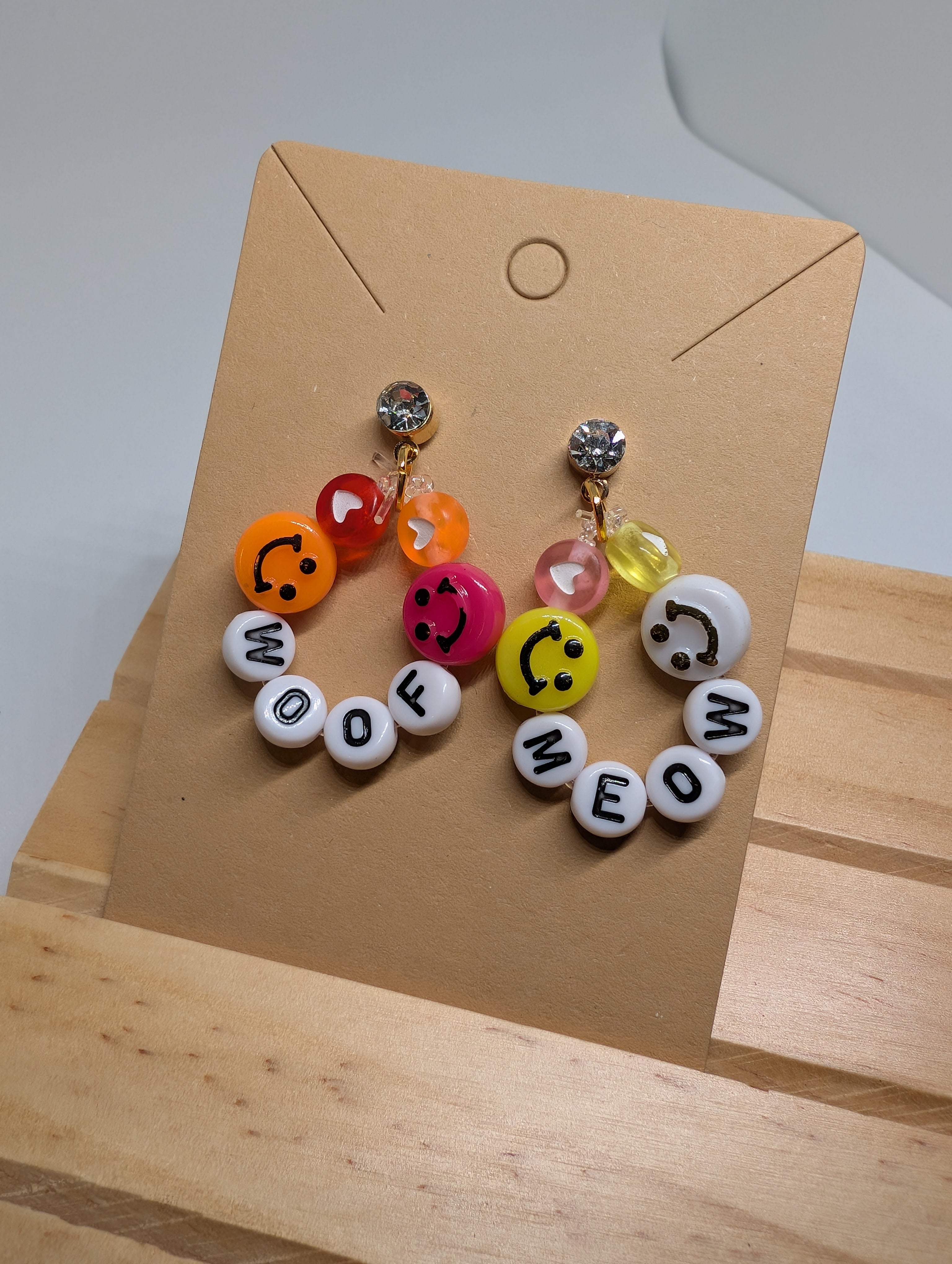 Woof And Meow Smiley Studs, handmade beaded earrings in multicolour, white, orange and gold