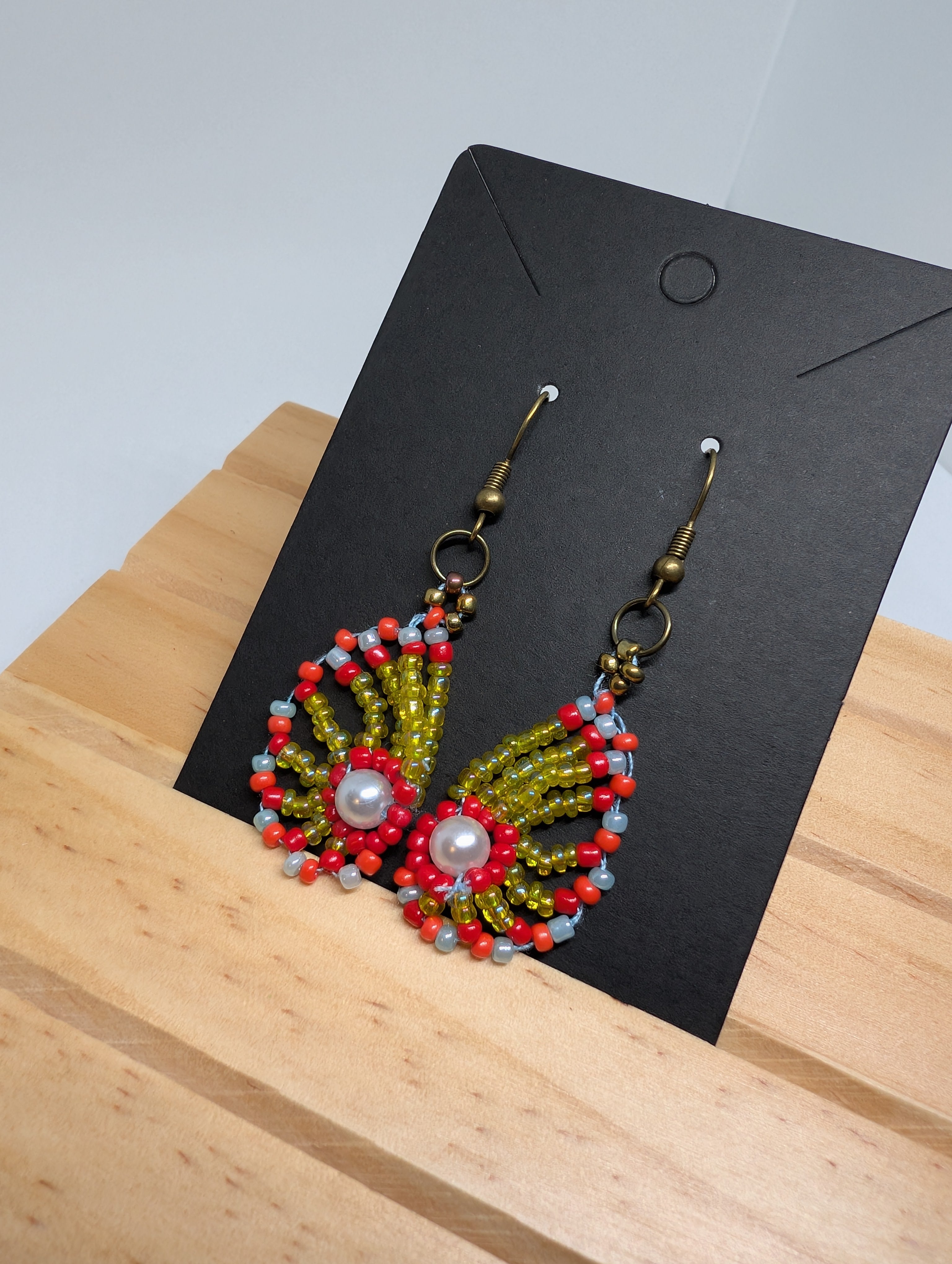 Olive And Coral Fan, handmade beaded earrings in green, red, blue and bronze